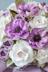 Beautiful arrangement of delicate purple and white flowers with intricate details, showcasing artistry and craftsmanship in floral design, perfect for decoration or gifting