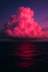 Vibrant pink cloud illuminated at sunset over dark ocean water with dramatic sky
