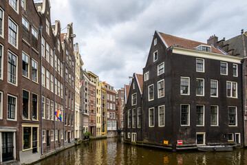 Historic old town of Amsterdam with its iconic boat canals and colorful facades, in Amsterdam,...