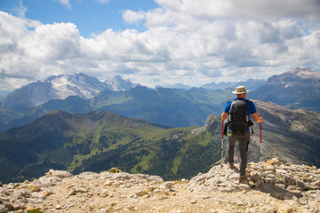 Fototapeta premium Hiker enjoys the view from Lagazuoi mountain over the italian Dolomites.