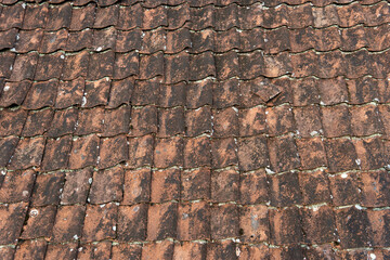 Detail of a roof surface made with old red brown roof tiles