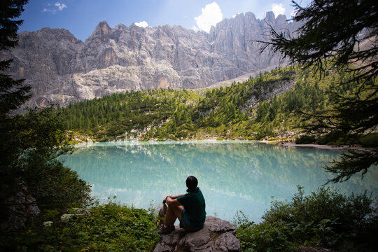 Travel woman man hiker at Sorapis Lake in the Dolomite Mountains