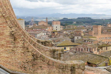 A detailed view of the rooftop of Siena Cathedral (Duomo di Siena), showcasing the striped marble...
