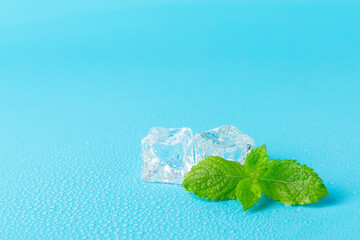 Mint and ice on texture background. Green fresh mint and ice cube. Mint leaves, ice cube and water...