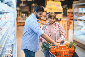 Indian couple shopping for groceries in supermarket