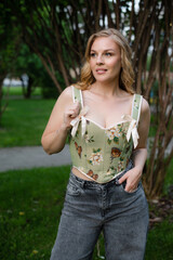  Beautiful slim blonde poses in boho wedding dresses and an embroidered corset on a summer terrace.