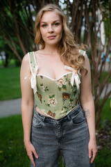  Beautiful slim blonde poses in boho wedding dresses and an embroidered corset on a summer terrace.