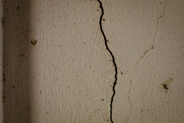 Close-up of a cracked wall showing structural damage or wear and tear.