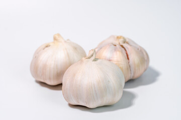 Close-up of a fresh garlic bulb isolated on a clean white background for culinary and health concept