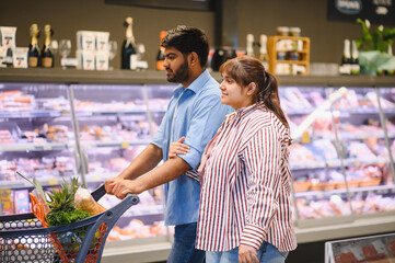 Indian couple shopping for groceries in supermarket