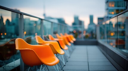 Obraz premium Modern Rooftop Patio Featuring Orange Chairs Overlooking a City Skyline at Dusk, Creating an Inviting Atmosphere