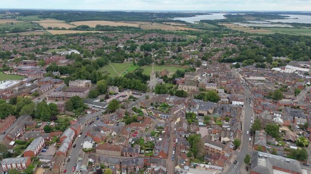 Aerial drone perspective of Oakham, Rutland, small English town with busy roads with cars, railway lines residential and industrial businesses England UK