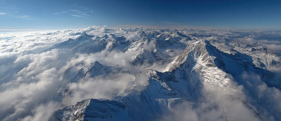 Fototapeta premium Sea of clouds enveloping mountain range with peaks emerging like islands. Ethereal wallpaper for digital devices.