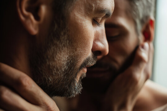 Close-up intimate moment of two adult men with gentle forehead touch and cheek hold. Emotional LGBTQ+ love portrait. Generative AI. 