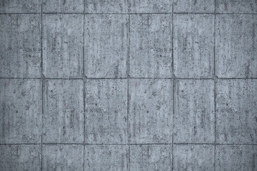 Textured gray concrete wall with a subtle grid pattern creating a modern, industrial backdrop