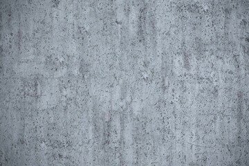 Fototapeta premium Detailed, gritty texture of a distressed concrete wall with subtle markings and a worn, gray surface