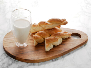 Simple rustic breakfast - home made mini challah and fresh milk. 