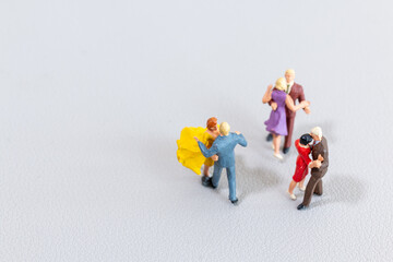 Miniature Couples Dancing on Light Background