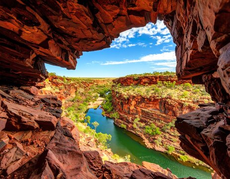 Canyon vista framed by a natural rock archway, showcasing a vibrant blue waterway winding through red rock formations under a bright sky - Powered by Adobe