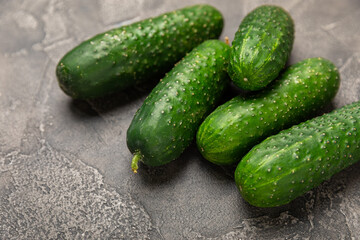 Cucumber on wooden background. Slice of cucumber on background. Fresh organic green cucumbers gherkin. Vegan. Salad ingredient. Farm vegetables. Cut vegetables with knife. Space for text. Copy space