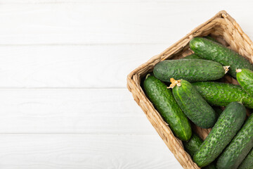 Cucumber on wooden background. Slice of cucumber on background. Fresh organic green cucumbers gherkin. Vegan. Salad ingredient. Farm vegetables. Cut vegetables with knife. Space for text. Copy space