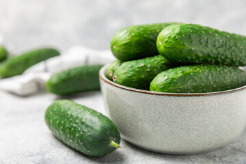 Cucumber on wooden background. Slice of cucumber on background. Fresh organic green cucumbers gherkin. Vegan. Salad ingredient. Farm vegetables. Cut vegetables with knife. Space for text. Copy space