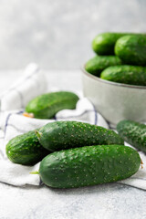 Cucumber on wooden background. Slice of cucumber on background. Fresh organic green cucumbers gherkin. Vegan. Salad ingredient. Farm vegetables. Cut vegetables with knife. Space for text. Copy space