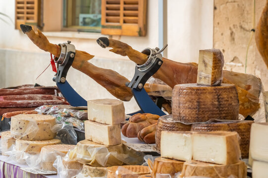 Food stall with dairy and meat products at Majorca farmers market Spain - Powered by Adobe