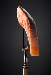 Smocked salmon on a black background.