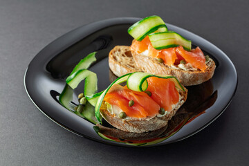 Sandwiches with smoked trout, cream cheese, fresh cucumber, and capers.
