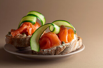 Open sandwiches with smoked trout filet, cream cheese, fresh cucumber, and capers.