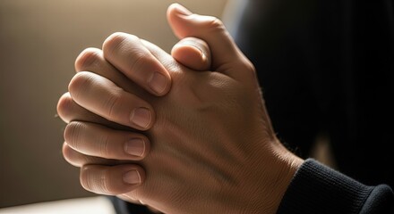 Interlocked Fingers in Contemplative Prayer, Bathed in Warm, Dramatic Light