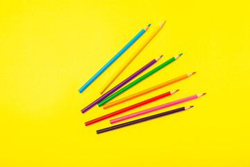 Colored pencils on a bright colored background. Equipment for coloring. Stationery for creativity.Back to school. Flatlay. Children's Creativity and Education. Rainbow.Space for text. Copy space.