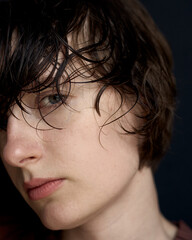 Intimate close-up portrait of woman with wet hair and natural makeup showing raw beauty