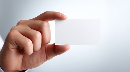 Obraz premium Hand Holding a Blank White Business Card Mockup for Branding and Promotion, Ready for Customization