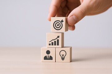 Business strategy, vision, and leadership represented with wooden blocks, hand placing the top one