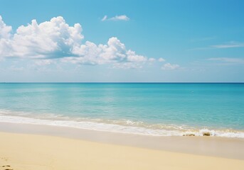 Obraz premium Serene seascape of a tropical paradise beach with golden sand and calm turquoise ocean under a blue sky with clouds.