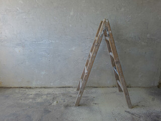 Painters wooden ladder against a bare wall