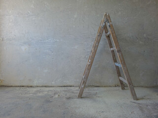 Painters wooden ladder against a bare wall