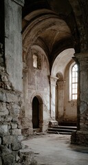 Interior of a crumbling church, arched passageway, remnants of frescoes
