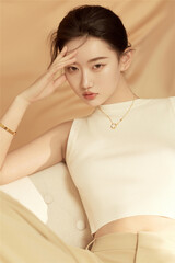 Young woman posing thoughtfully in soft lighting.