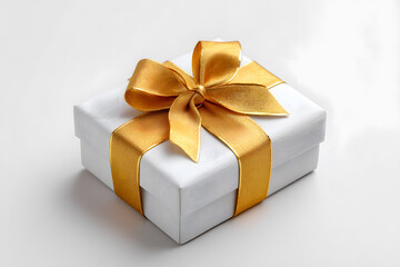 Obraz premium Stylish white gift box with shiny golden ribbon and elegant bow. A luxurious and minimal holiday composition ideal for branding and seasonal product visuals.