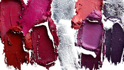 Swirled lipstick swatches in shades of pink red and purple on textured surface makeup beauty