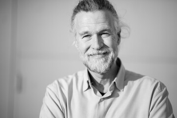 Smiling senior man in black and white portrait