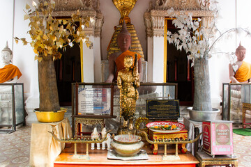 Ancient golden buddha statue in antique ubosot for thai people travelers travel visit respect pray...
