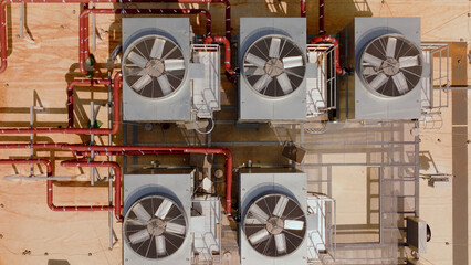 Industrial rooftop cooling system with ventilation fans and pipes