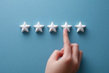 Hand pointing at four white stars