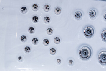 Close-up view of spa bath jets on a smooth white surface showcasing modern design elements