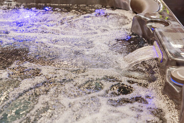 Relaxing hot tub with bubbling water and soft lighting creating a tranquil atmosphere for leisure