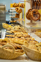 Freshly baked assortment of pastries and bread displayed in a bakery with tempting treats
